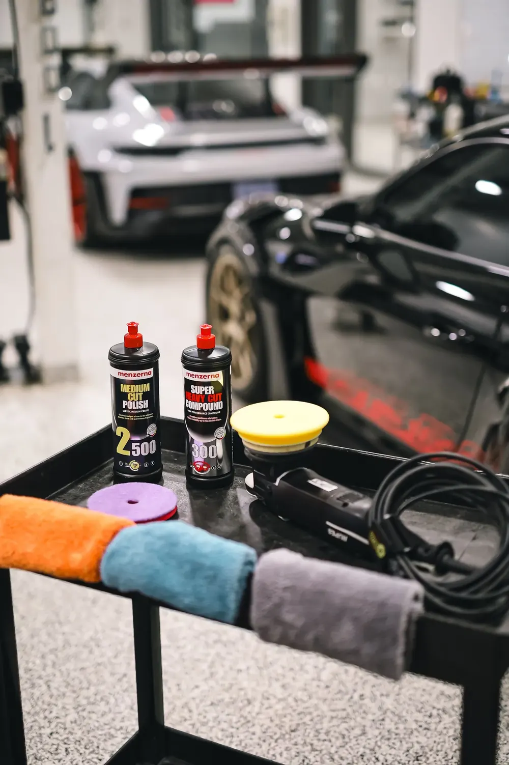 A black sports car under studio lights, the kind of work a site should show